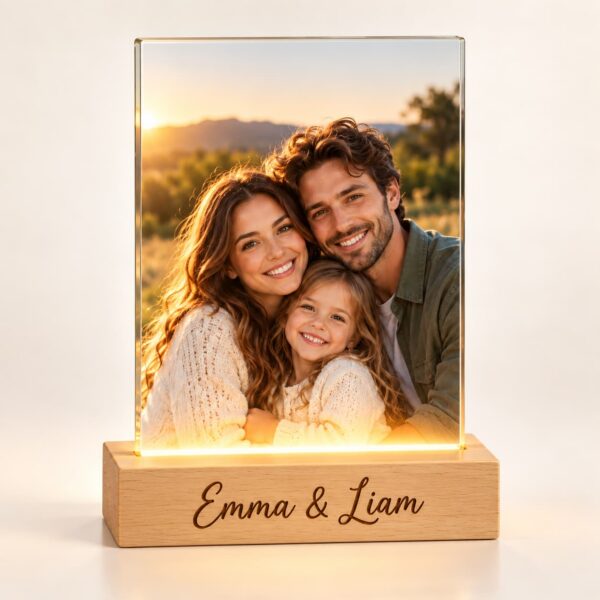 Personalized glass photo lamp glowing with a family photo on a wooden base engraved with a custom name