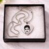 Personalized silver heart necklace with custom portrait engraving presented in a gift box