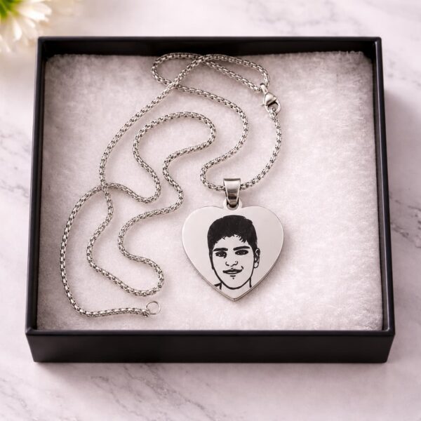 Personalized silver heart necklace with custom portrait engraving presented in a gift box