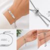 Close-up of the adjustable slider clasp on a personalized stainless steel name bracelet, showing the easy-to-adjust fit and polished finish.