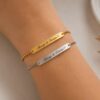 Personalized adjustable stainless steel bracelet worn on wrist in gold and silver colors